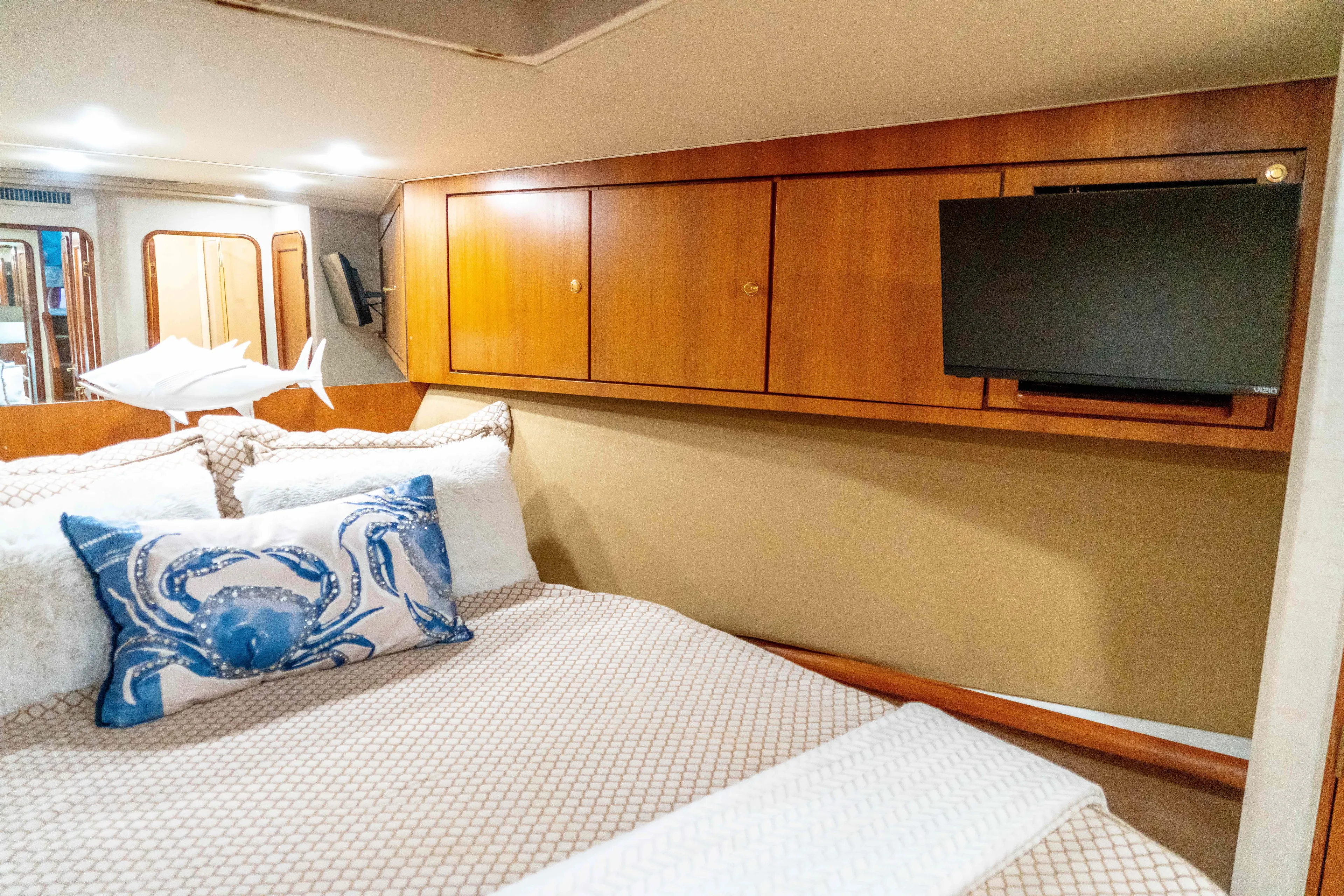  Yacht Photos Pics Luxurious cabin interior of 1997 Ocean Yachts 60 Sport Fish with cozy bedding and TV.