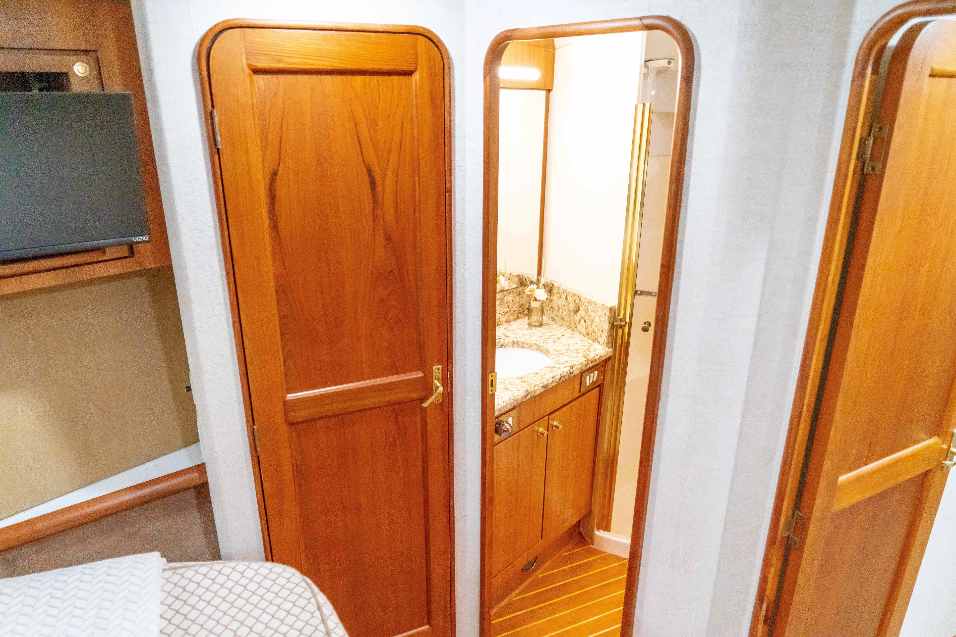  Yacht Photos Pics Interior of 1997 Ocean Yachts 60 Sport Fish, featuring wooden doors and a compact bathroom.
