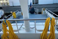 Deck of 1997 Custom Survey 55 boat with yellow ropes and docked at marina.