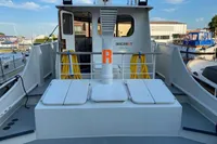 Custom Survey 55 boat, 1997 model, docked with visible deck and equipment.