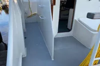 Side deck of a 1997 Custom Survey 55 boat with open cabin door.