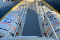Deck view of 1997 Custom Survey 55 boat with safety equipment and railings.