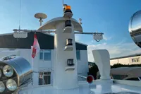 Custom Survey 55 boat deck with radar and lights, 1997 model, clear sky background.
