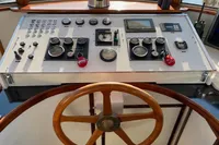 Control panel of a 1997 Custom Survey 55 boat with wooden steering wheel.