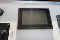 Control panel of a 1997 Custom Survey 55 boat with a dusty screen.