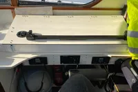 Navigation station on a 1997 Custom Survey 55 boat with control panels and safety gear.