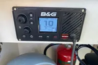 Marine radio on Custom Survey 55, 1997 model, with distress button and fire extinguisher nearby.