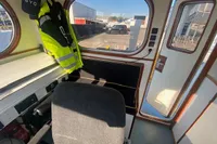 Interior of a 1997 Custom Survey 55 boat with a control station and safety gear.