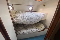 Bunk beds in a 1997 Custom Survey 55 boat cabin with floral bedding.