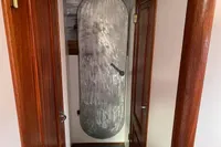 Metal door in wooden hallway of 1997 Custom Survey 55 boat.