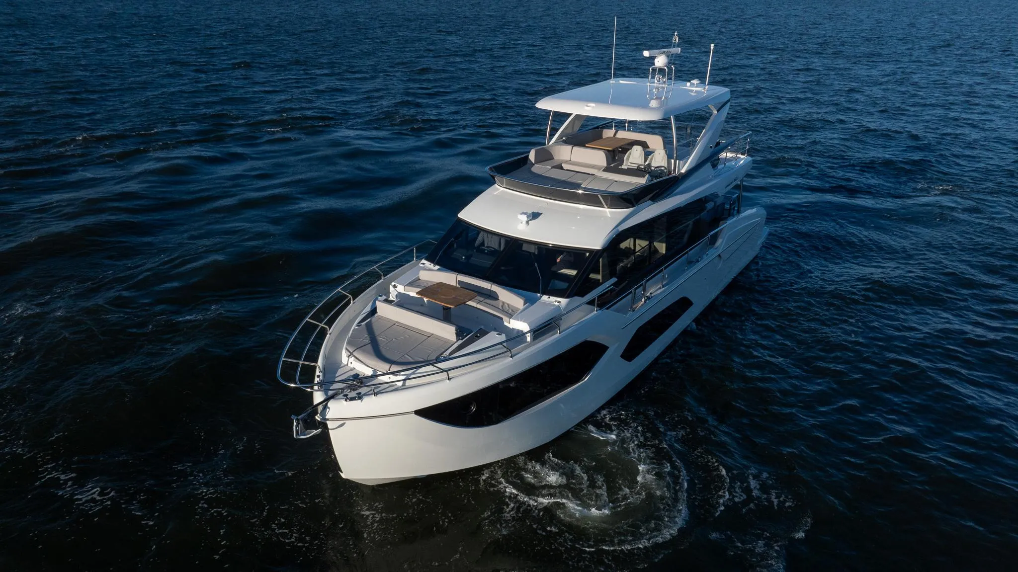 2025 Absolute 60 Fly yacht cruising on open water, showcasing sleek design and luxury features.