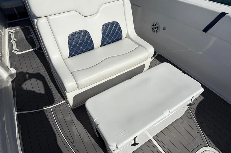 Yacht Photos Pics White cushioned seat and cooler on 2020 Midnight Express 34' Open boat deck.