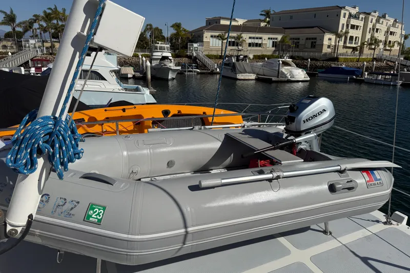 Blue Yacht Photos Pics Inflatable boat with Honda motor on 1989 Nordhavn 46 yacht, docked in marina.