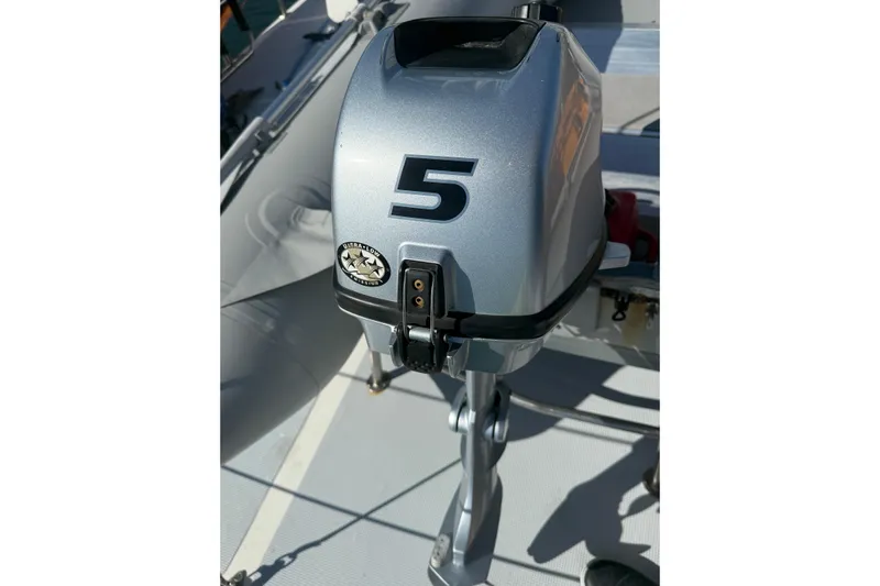 Blue Yacht Photos Pics Outboard motor on a 1989 Nordhavn 46 yacht, featuring a silver casing with a "5" label.