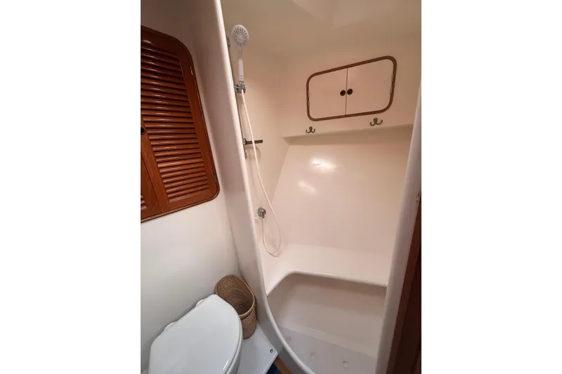 Blue Yacht Photos Pics Bathroom interior of 1989 Nordhavn 46 yacht with shower and wooden accents.