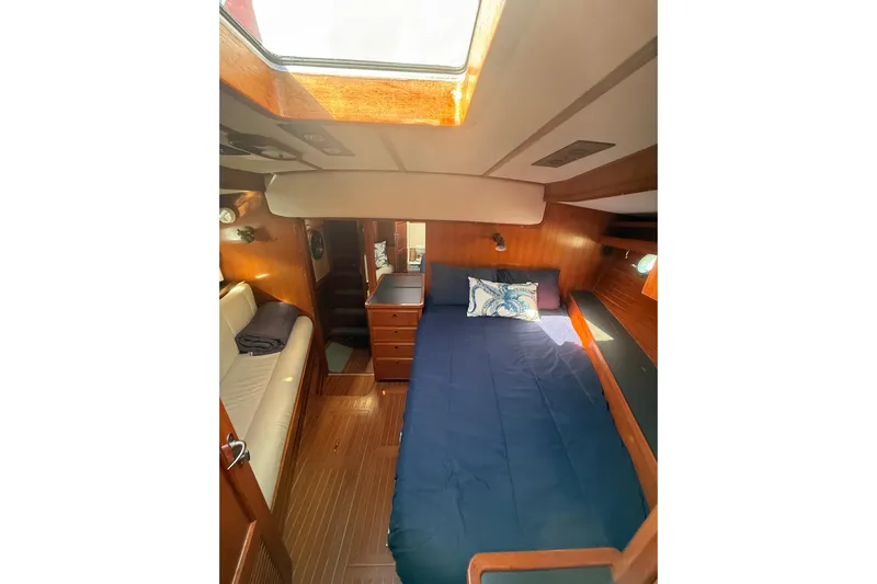 Blue Yacht Photos Pics Cozy cabin interior of 1989 Nordhavn 46 yacht with bed and seating area.