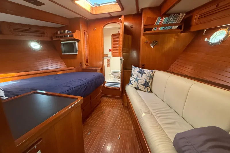 Blue Yacht Photos Pics Luxurious 1989 Nordhavn 46 yacht interior with cozy cabin, bed, and seating area.