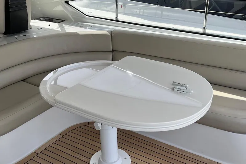  Yacht Photos Pics Luxurious seating area on a 2010 Pershing 56 yacht with a sleek white table.