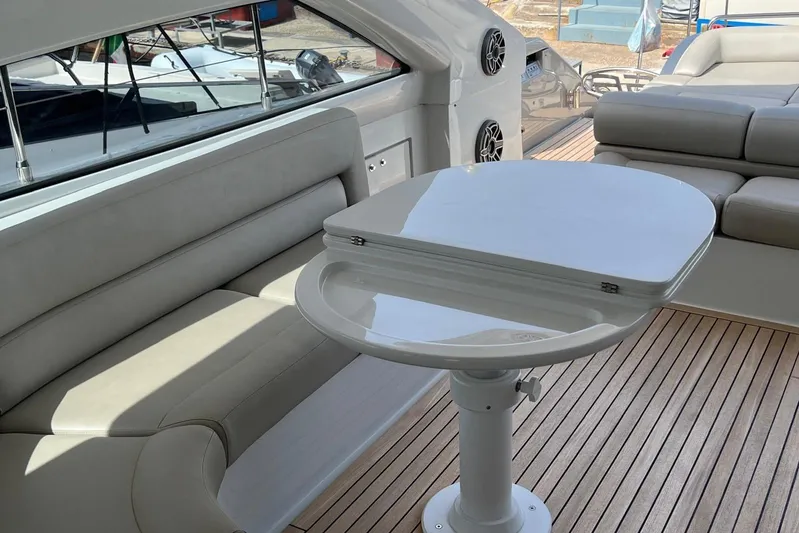  Yacht Photos Pics Luxurious interior of 2010 Pershing 56 yacht with sleek seating and modern table design.