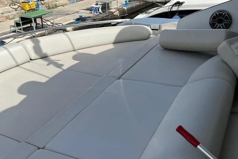 Yacht Photos Pics Luxurious sunbathing area on a 2010 Pershing 56 yacht, featuring plush seating.