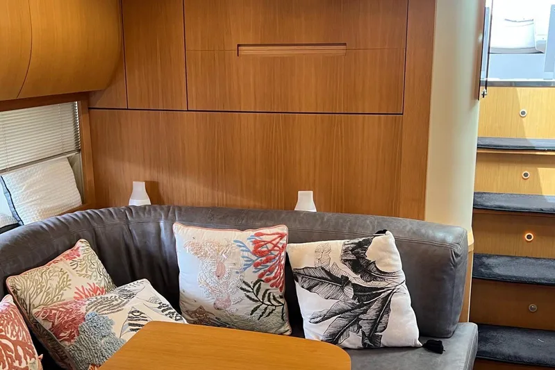  Yacht Photos Pics Luxurious interior of 2010 Pershing 56 yacht with stylish cushions and wooden paneling.