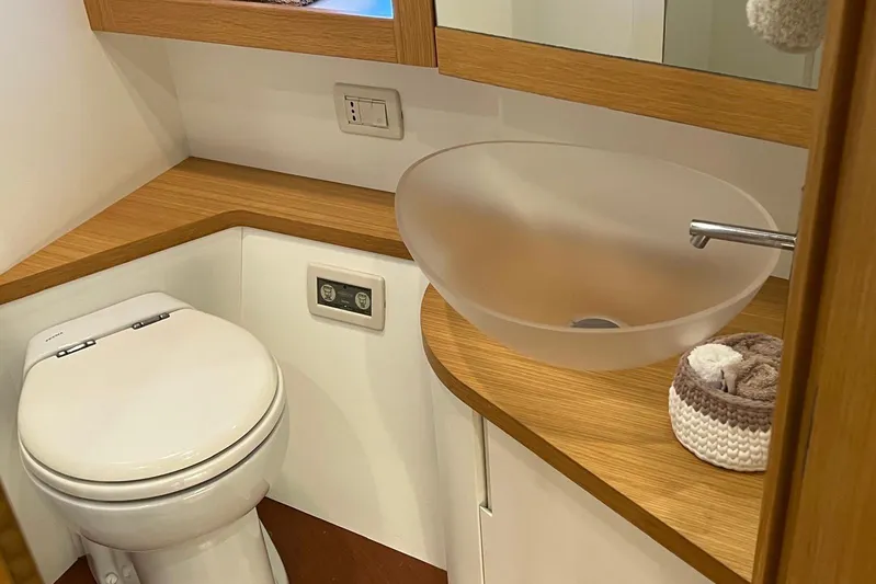  Yacht Photos Pics Luxury yacht bathroom with modern frosted glass sink and wooden accents, Pershing 56, 2010 model.