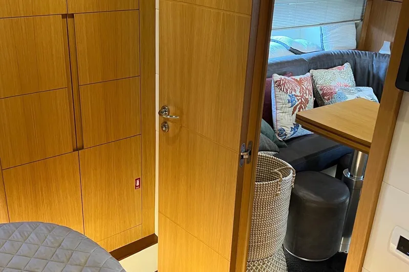  Yacht Photos Pics Interior of 2010 Pershing 56 yacht with wooden cabinetry and cozy seating area.