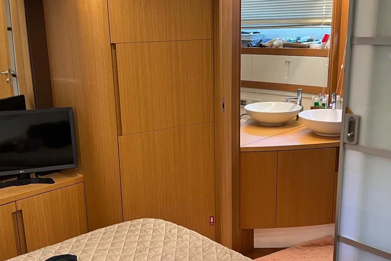  Yacht Photos Pics Luxurious interior of 2010 Pershing 56 yacht featuring wood paneling, TV, and modern bathroom.
