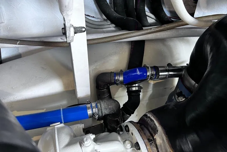  Yacht Photos Pics Engine compartment of a 2010 Pershing 56 yacht, featuring blue and black hoses.