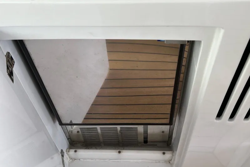  Yacht Photos Pics Interior view of a 2010 Pershing 56 yacht, featuring a wooden floor and white paneling.