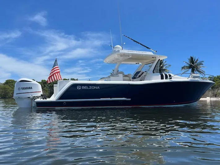 Happily Ever After Yacht Photos Pics 2016 Belzona 327 WA boat on water with Yamaha engine and American flag.