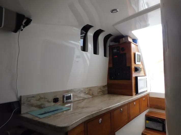 Happily Ever After Yacht Photos Pics Interior of 2016 Belzona 327 WA boat with modern kitchen and control panel.