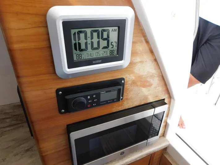 Happily Ever After Yacht Photos Pics Control panel on 2016 Belzona 327 WA boat with clock and electronic display.