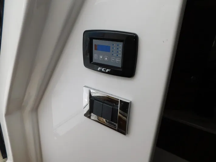 Happily Ever After Yacht Photos Pics Control panel and switches on a 2016 Belzona 327 WA boat interior.
