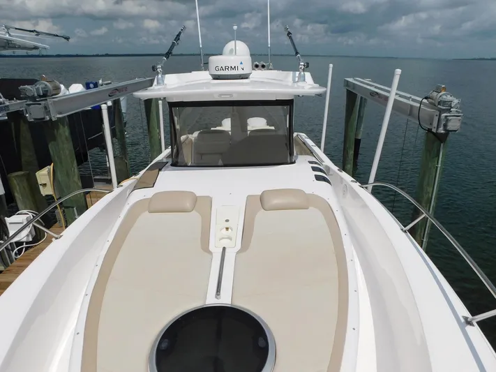 Happily Ever After Yacht Photos Pics 2016 Belzona 327 WA boat docked, featuring spacious deck and Garmin equipment.