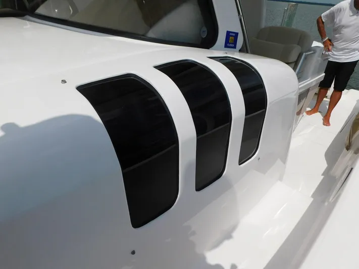 Happily Ever After Yacht Photos Pics 2016 Belzona 327 WA boat with sleek black air vents on white exterior.