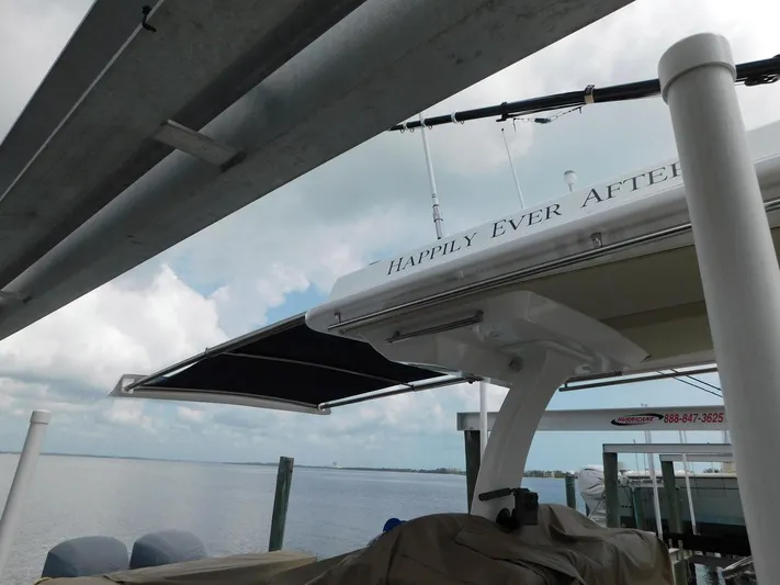 Happily Ever After Yacht Photos Pics Belzona 327 WA boat docked, featuring "Happily Ever After" text, under a cloudy sky.
