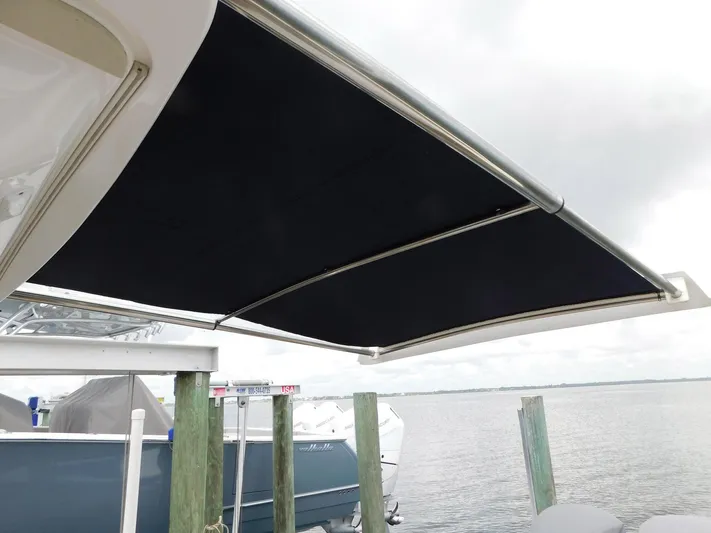 Happily Ever After Yacht Photos Pics 2016 Belzona 327 WA boat with extended black canvas sunshade at dock.