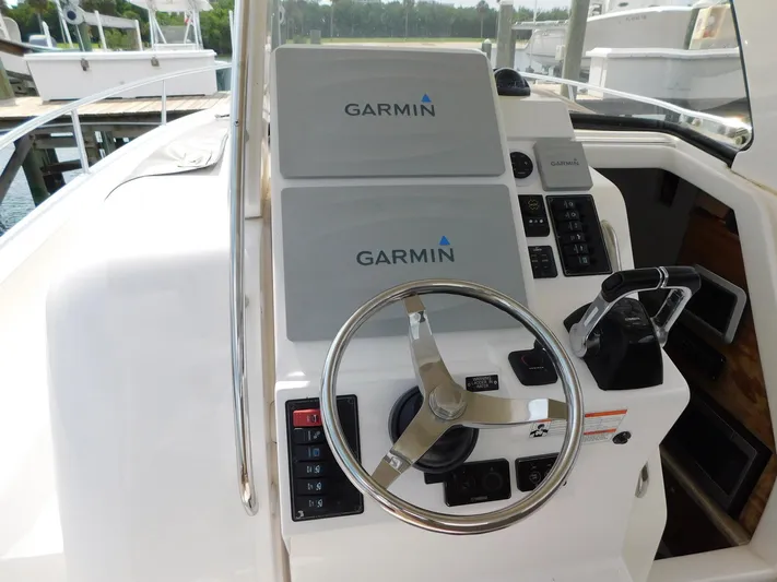Happily Ever After Yacht Photos Pics Belzona 327 WA 2016 boat helm with Garmin navigation displays and steering wheel.