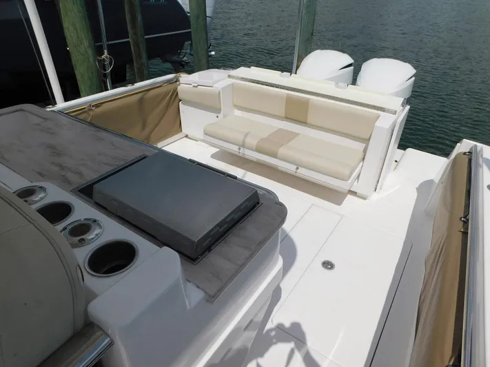 Happily Ever After Yacht Photos Pics 2016 Belzona 327 WA boat deck with seating and storage, docked by the water.