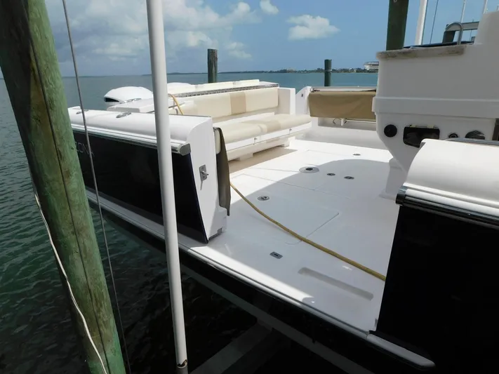 Happily Ever After Yacht Photos Pics Belzona 327 WA 2016 boat docked, featuring spacious deck and seating area.