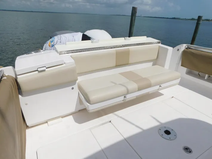 Happily Ever After Yacht Photos Pics 2016 Belzona 327 WA boat with beige seating, docked by calm waters.