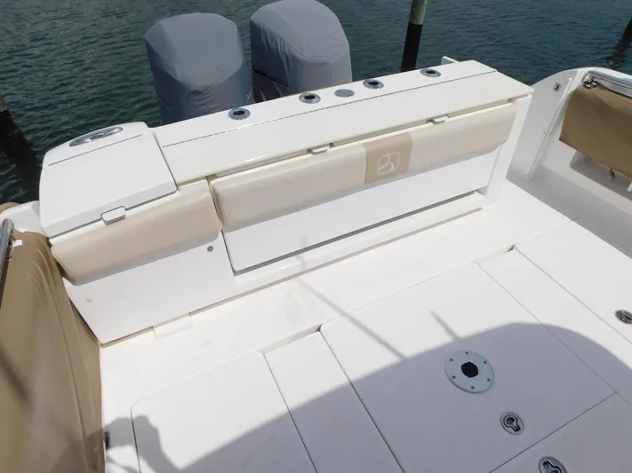 Happily Ever After Yacht Photos Pics 2016 Belzona 327 WA boat deck with cushioned seating and covered engines.