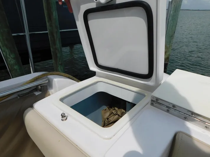 Happily Ever After Yacht Photos Pics Open storage compartment on 2016 Belzona 327 WA boat, docked by the water.