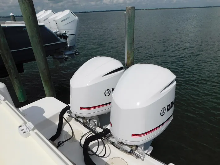 Happily Ever After Yacht Photos Pics Twin Yamaha outboard motors on a 2016 Belzona 327 WA boat docked by the water.