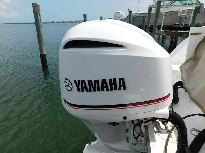 Happily Ever After Yacht Photos Pics Yamaha outboard motor on 2016 Belzona 327 WA boat, docked by the water.