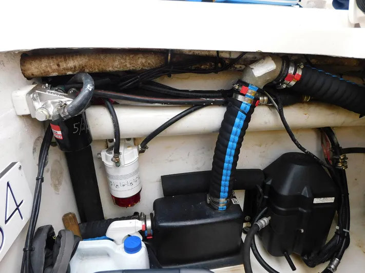 Happily Ever After Yacht Photos Pics Engine compartment of a 2016 Belzona 327 WA with hoses and components visible.