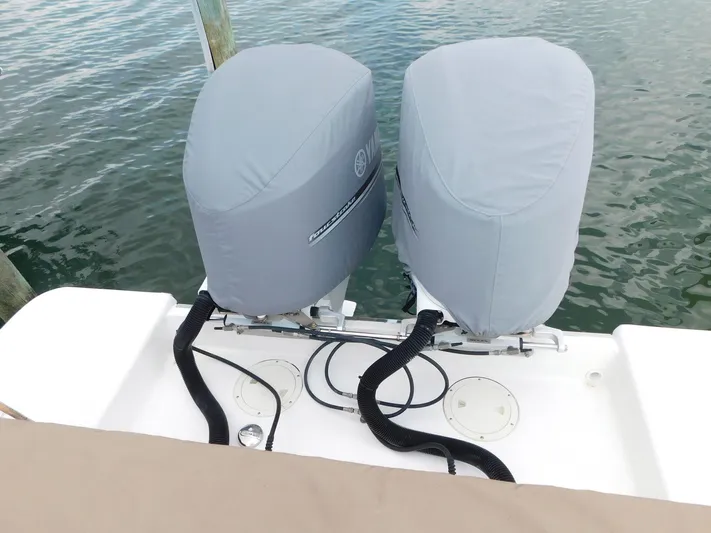 Happily Ever After Yacht Photos Pics Twin covered outboard motors on a 2016 Belzona 327 WA boat.