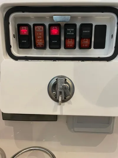 Silver Lining Yacht Photos Pics Control panel of a 2021 Back Cove 34 O boat with switches and key lock.