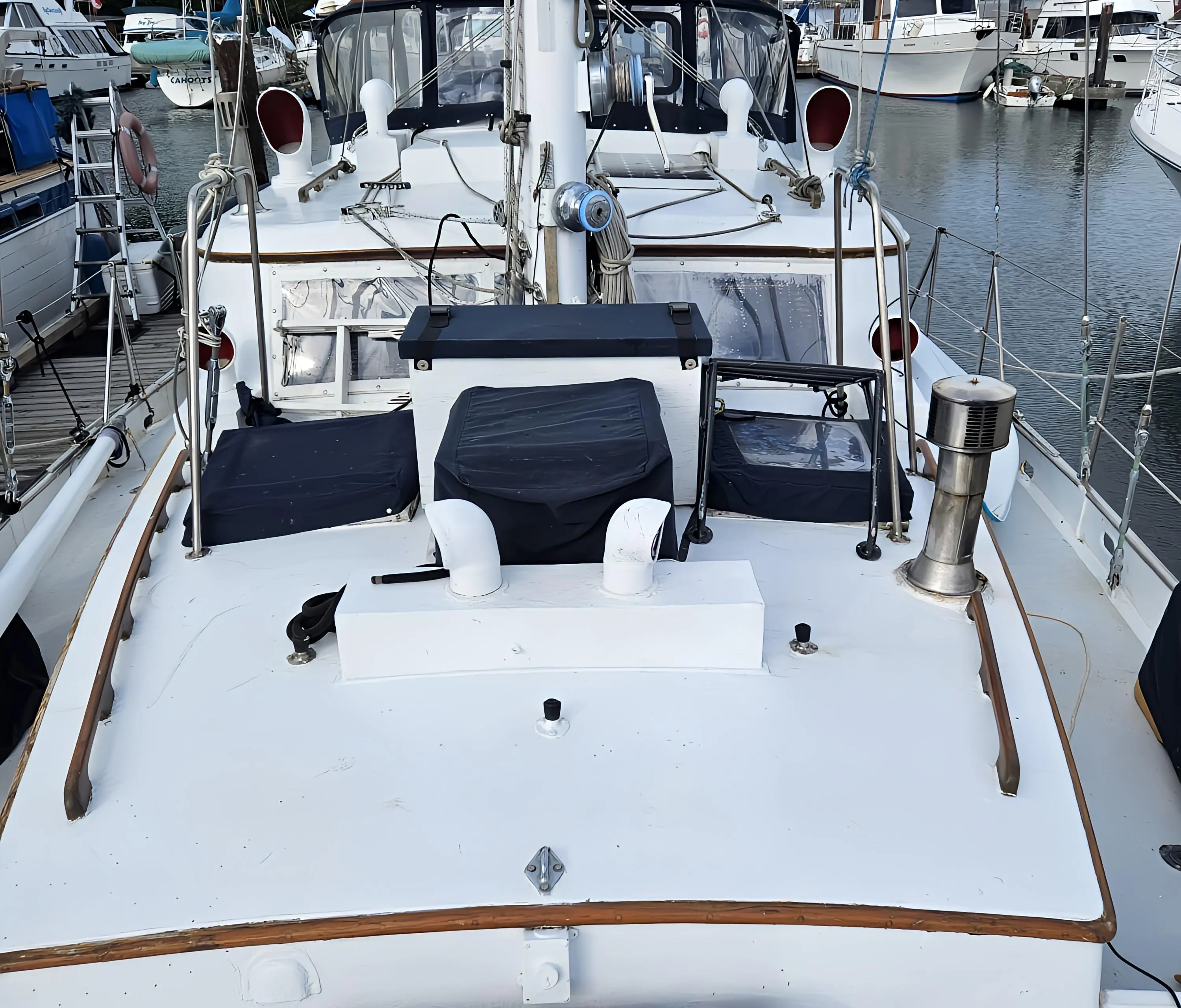 1969 Custom Rhodes Motorsailer Steel Ketch docked at a marina, showcasing its deck and rigging.